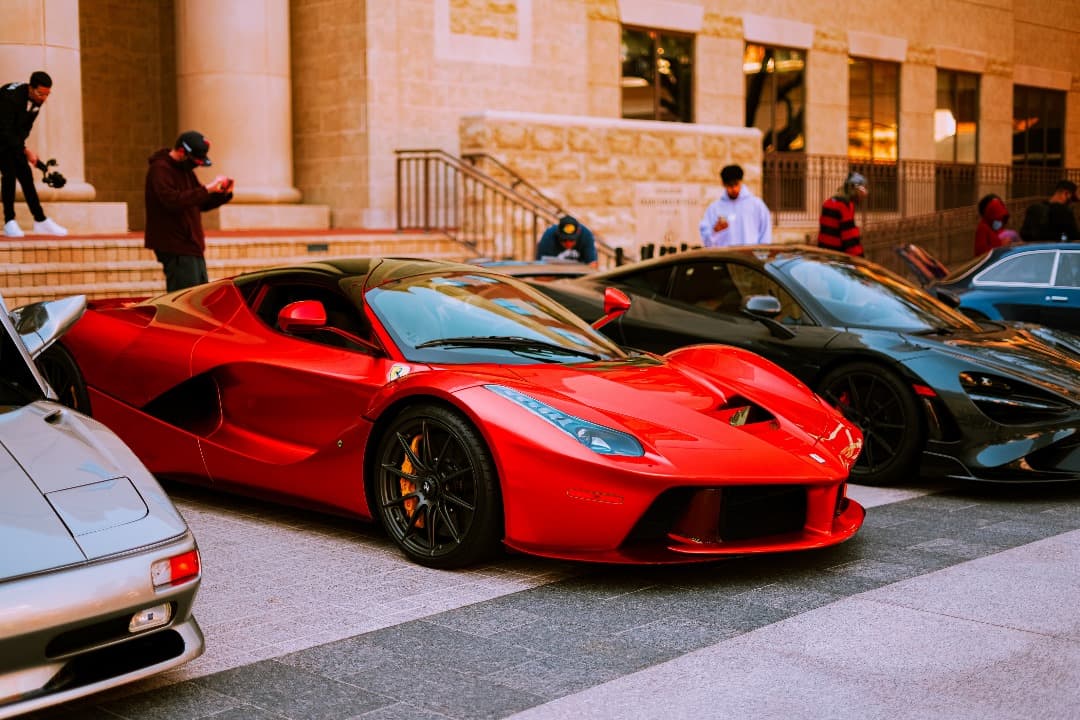 Red sports car alongside other vehicles