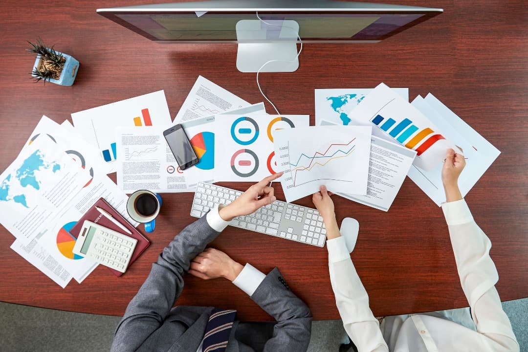 Team reviewing printed charts and business reports