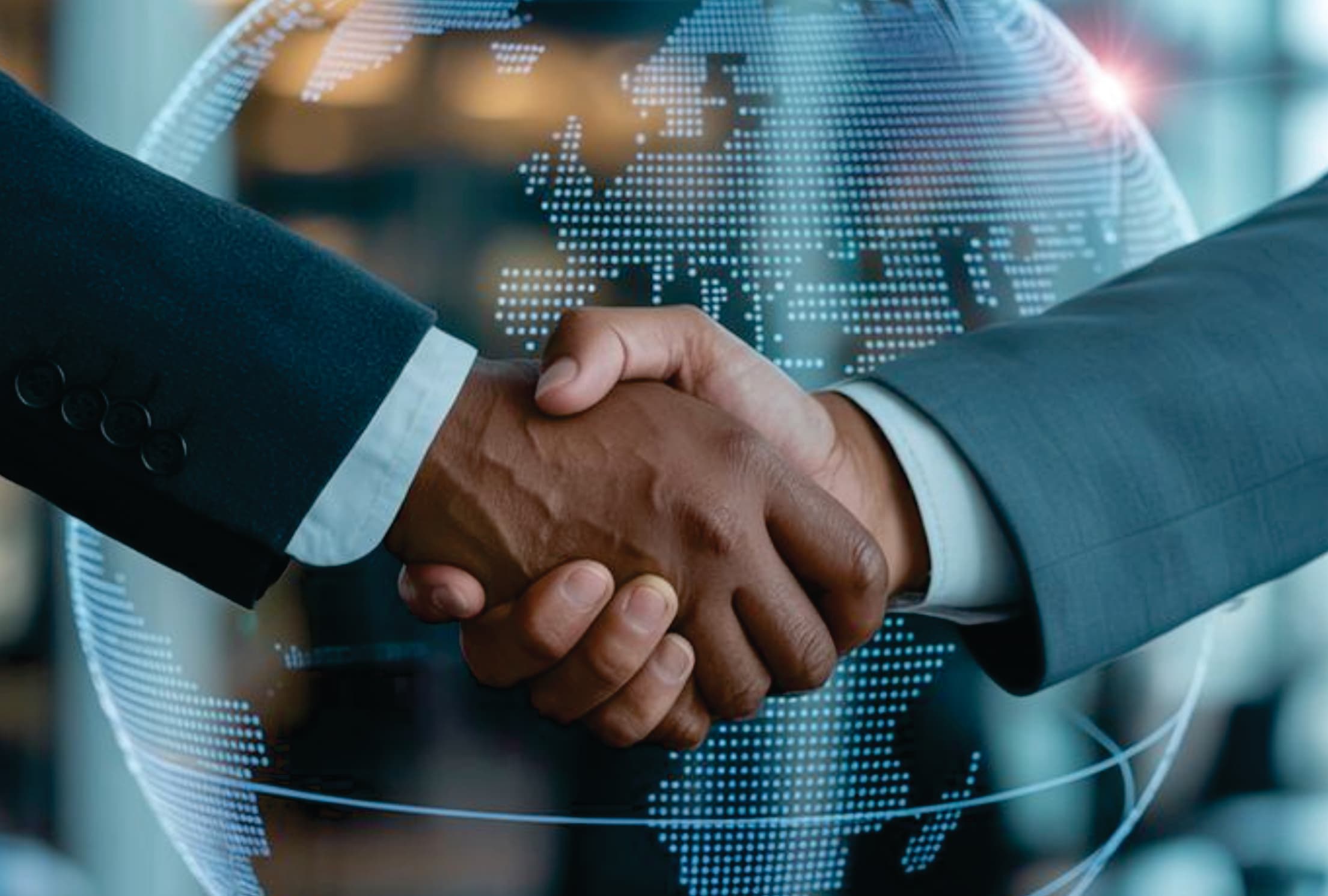 Business handshake in front of a digital globe, representing global collaboration